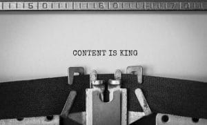 Text 'Content is King' typed on retro typewriter in black and white.